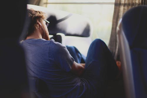 Free Man Sitting Near Window Stock Photo