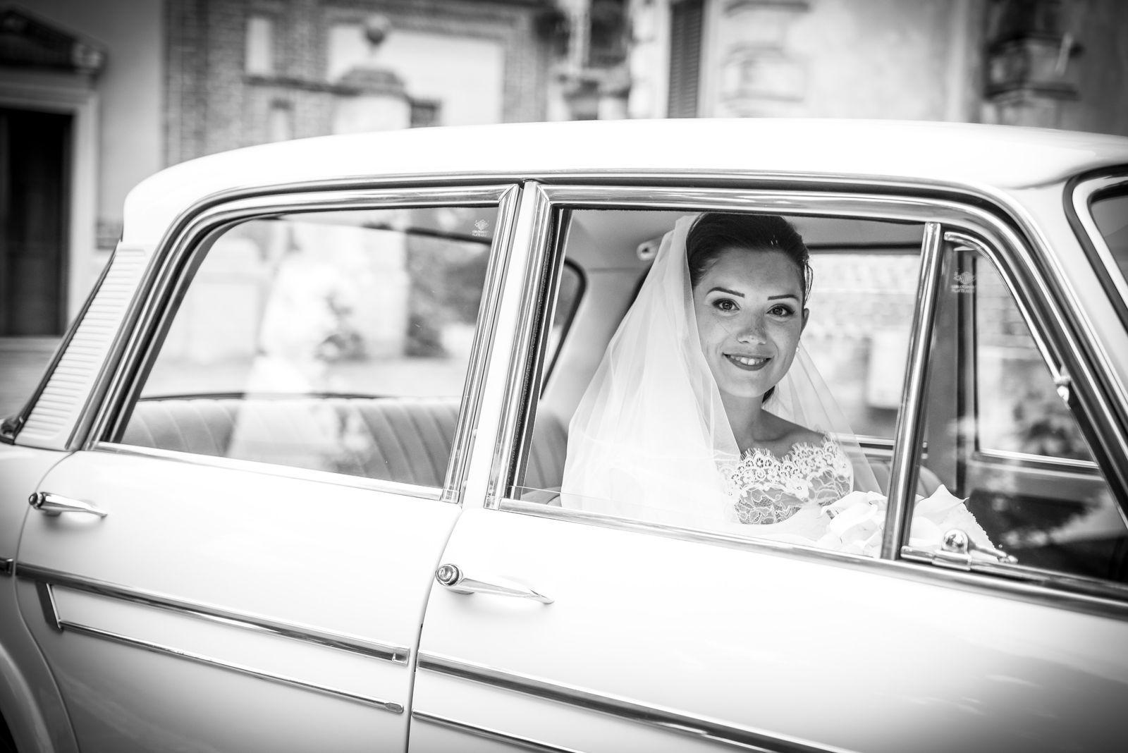 Sposa a bordo di un’auto classica durante un matrimonio in Italia