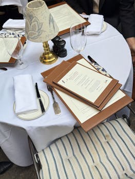 Classy dining table with menus and elegant decor in a restaurant setting.