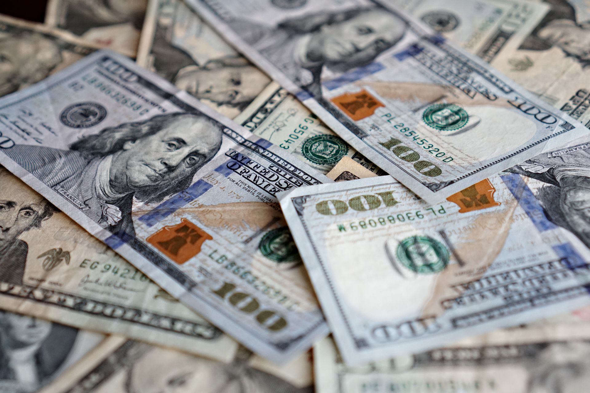 A collection of US dollar bills featuring different denominations, ideal for finance themes.