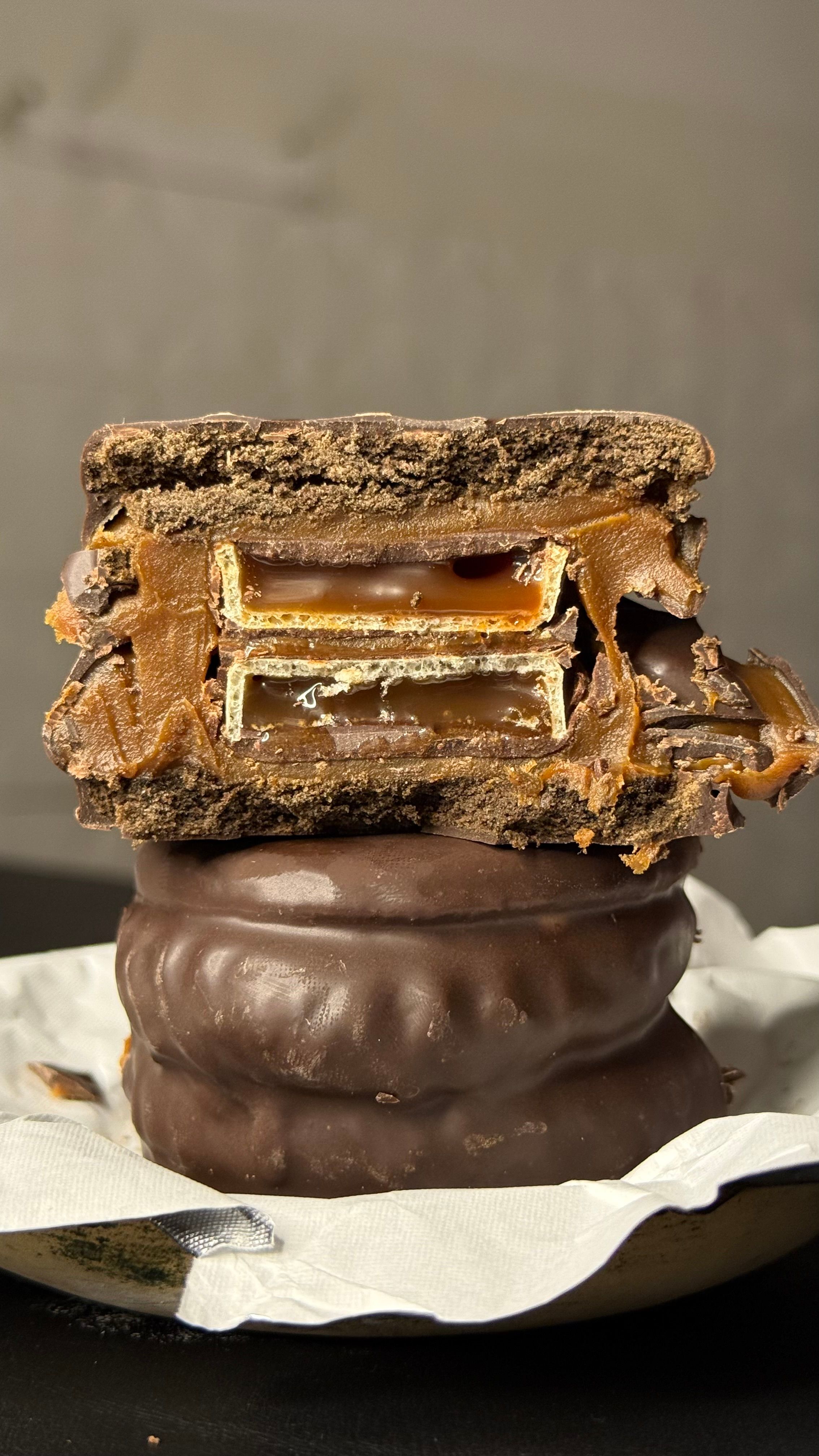 Delicious alfajor with caramel layered inside, showcasing a sweet Argentinian treat.
