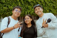 Three Friends Posing Outdoors with Microphone