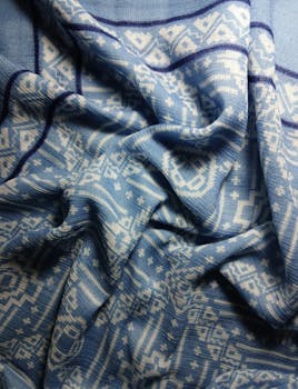 Detailed shot of a blue and white geometric patterned fabric with folds.