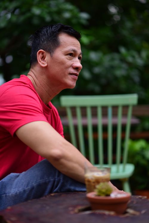 Free Man enjoying a peaceful moment outdoors with coffee and cactus. Stock Photo