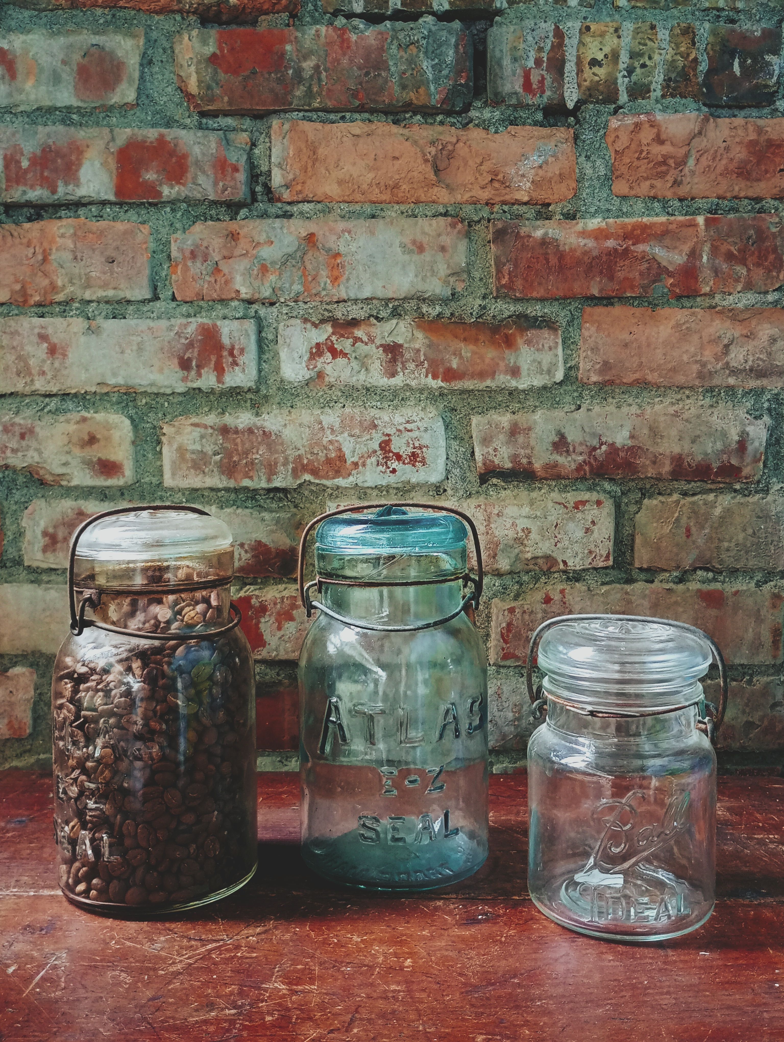 Mason jar pendant lights hanging above a farmhouse style coffee bar with wooden counters