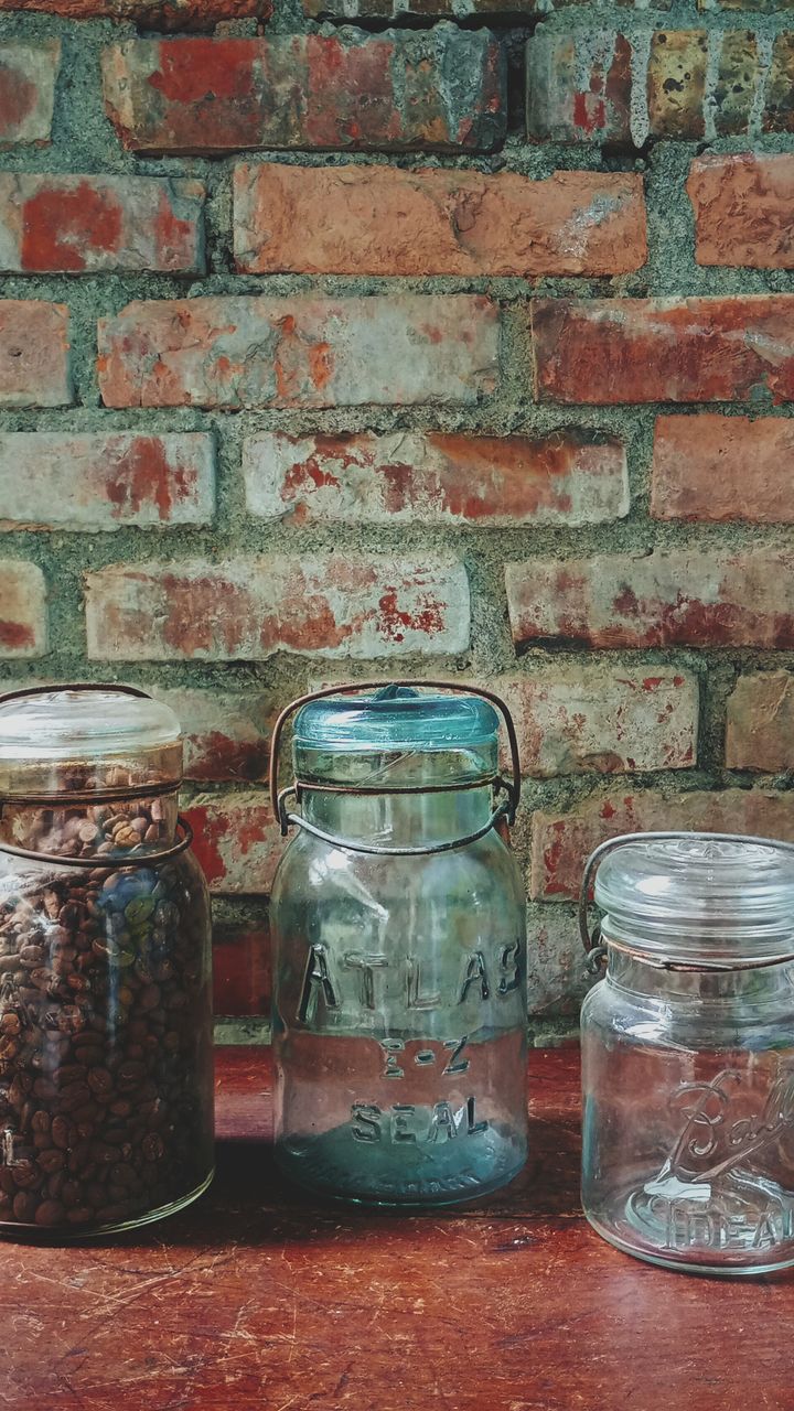 Mason jar pendant lights hanging above a farmhouse style coffee bar with wooden counters