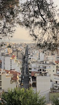Bird's eye view of a sprawling urban cityscape with a focus on street symmetry at sunset.