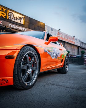 Eye-catching orange sports car parked at a vibrant car shop in Ankara, Türkiye.