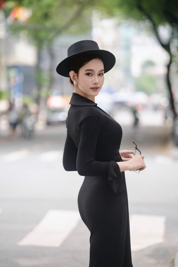 Elegant woman in black midi dress