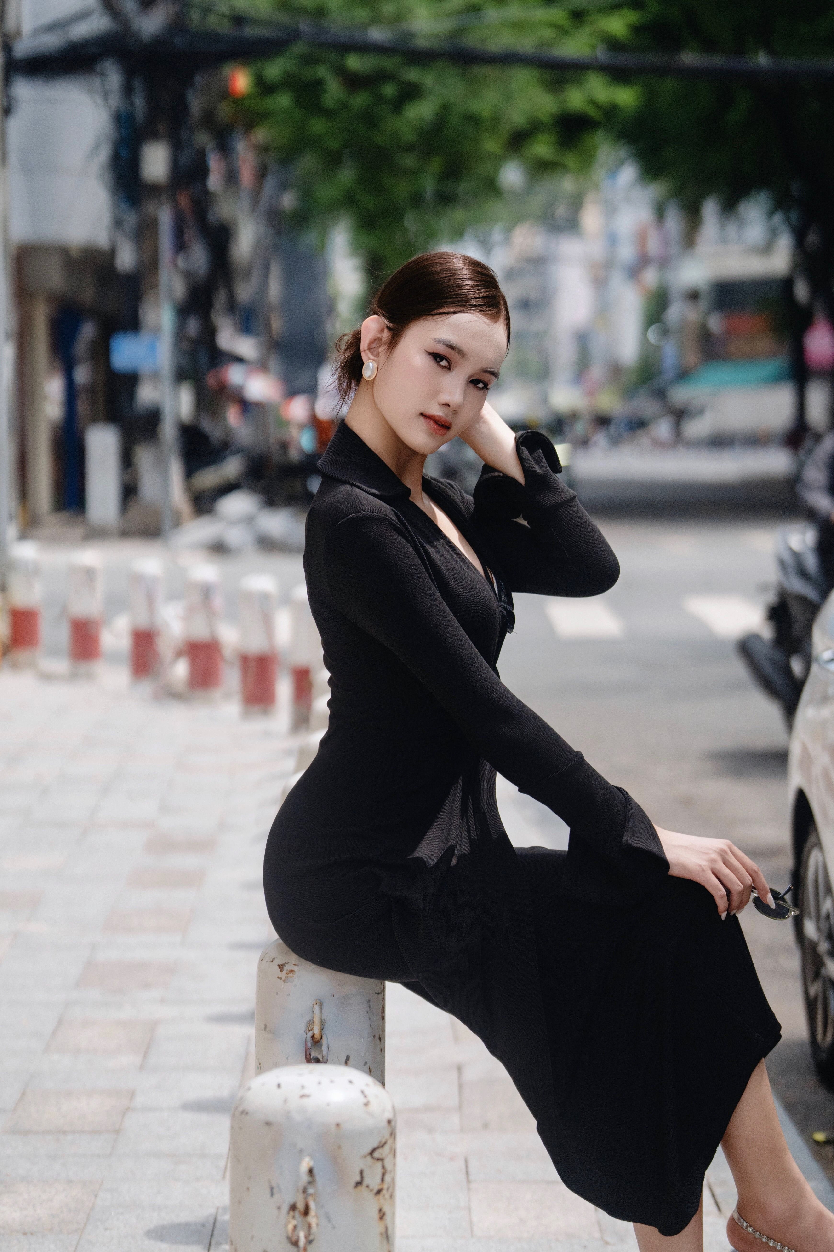 Woman in black basic midi dress styled up