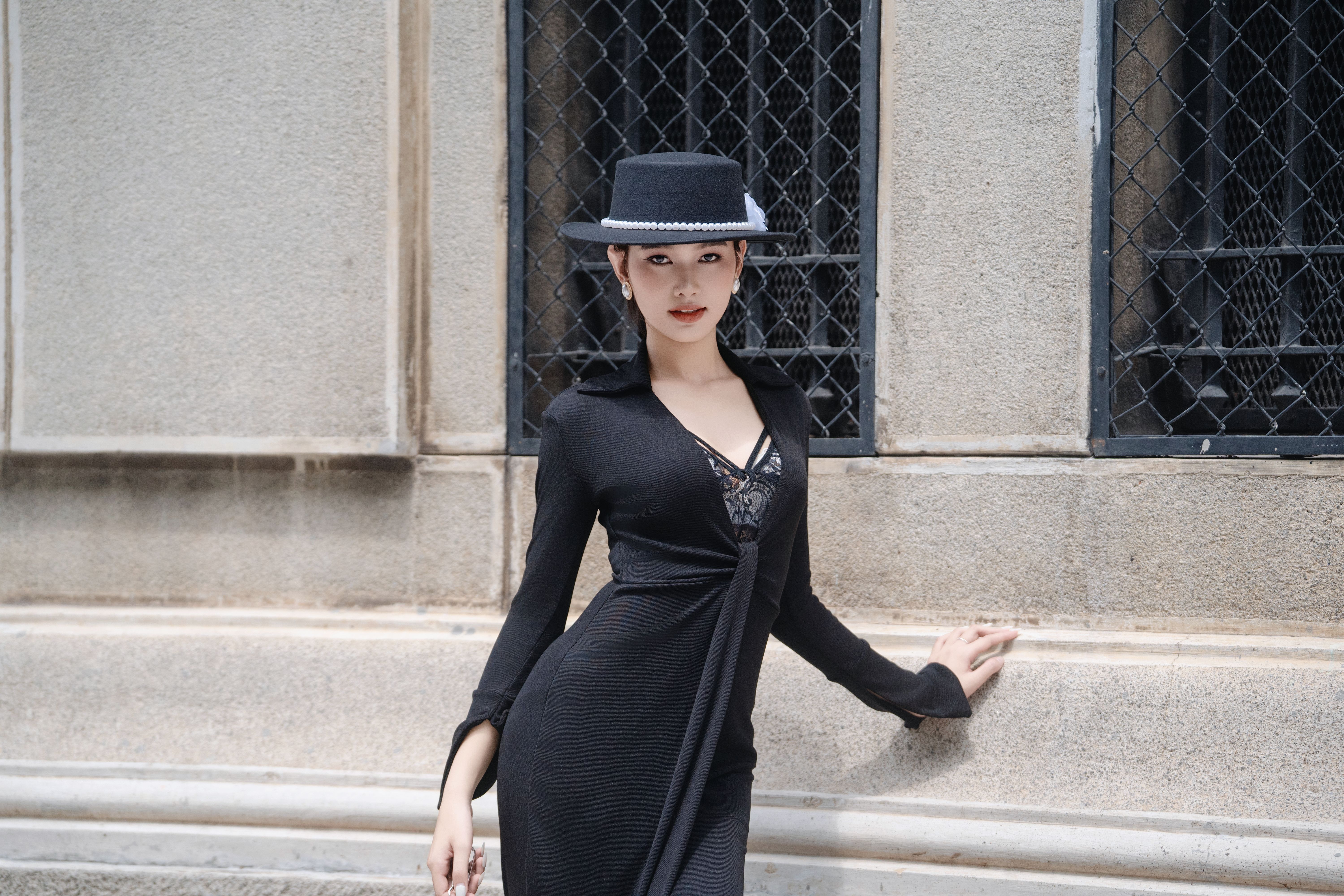 black dress and hat Woman in a little a Fabric eco leather Stylish Woman in Black Dress