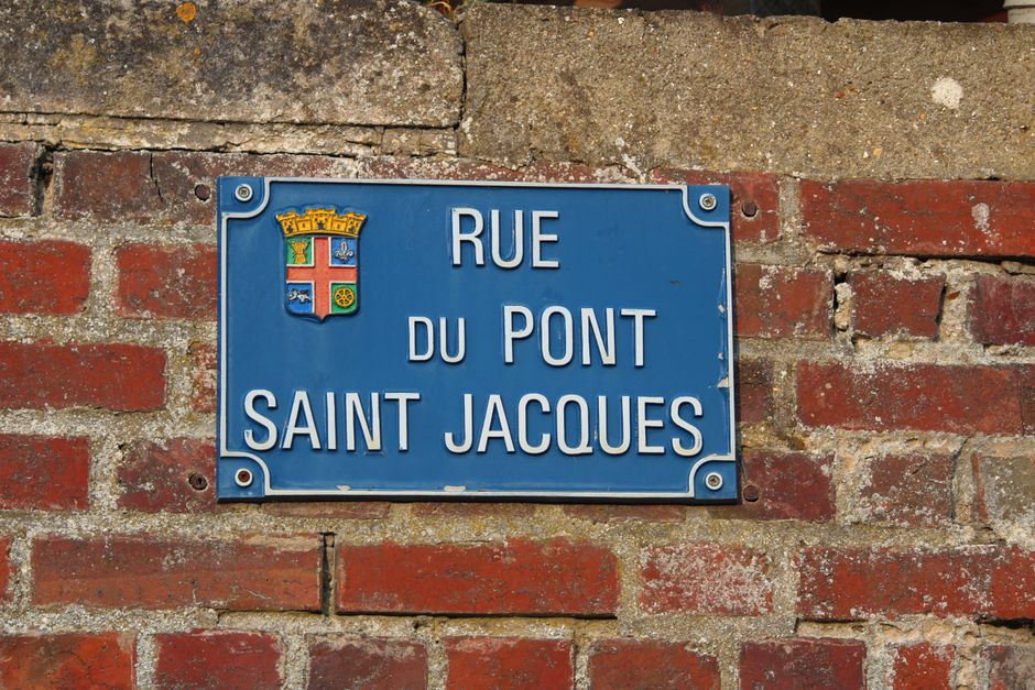 A vibrant street sign on a brick wall in Bornel, Hauts-de-France, France.