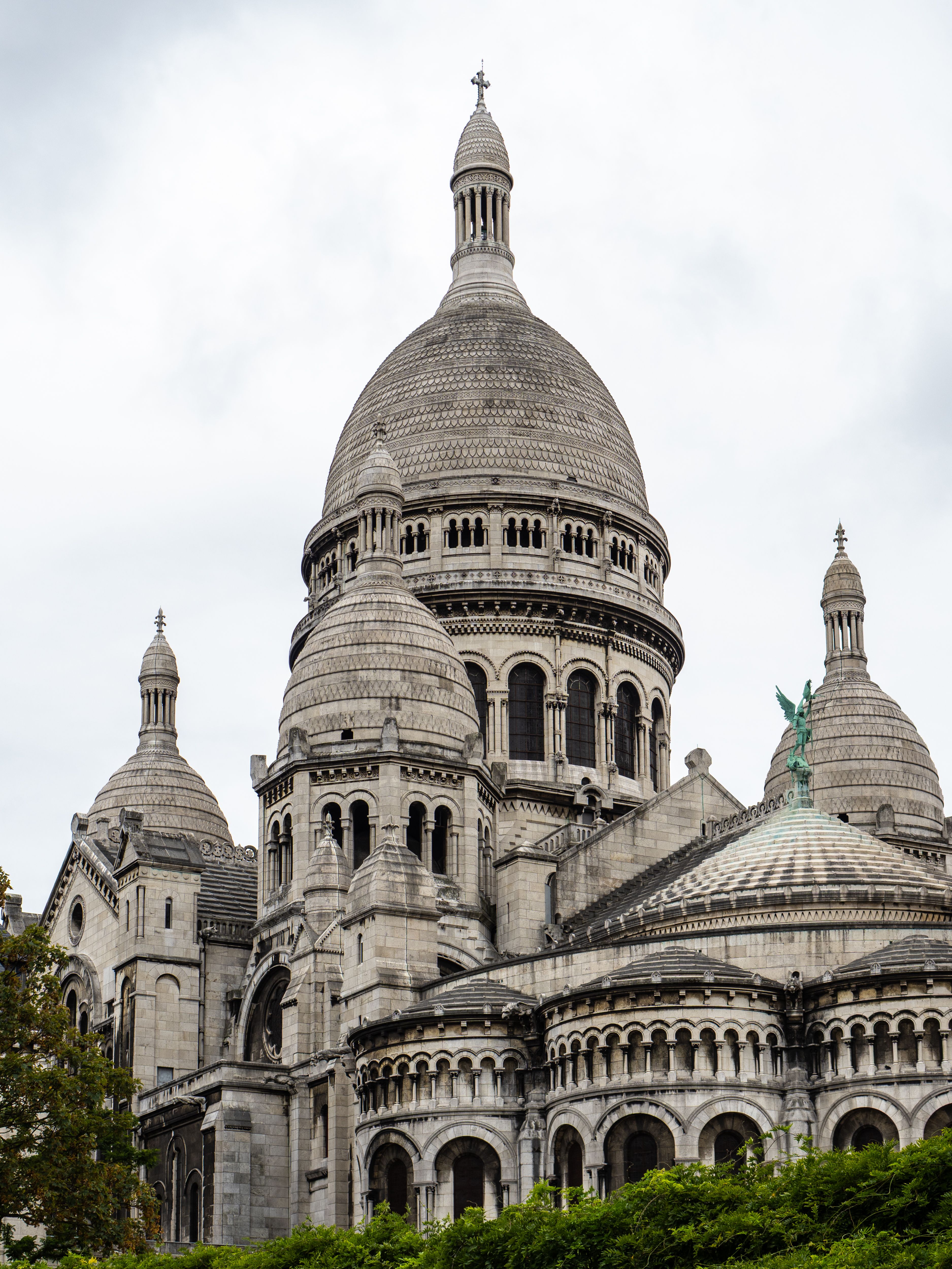 Explore the iconic Sacre-Coeur Basilica in Paris, a stunning architectural marvel under cloudy skies.