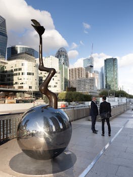 Contemporary sculpture with Paris la Défense skyline in the background, featuring modern architecture.