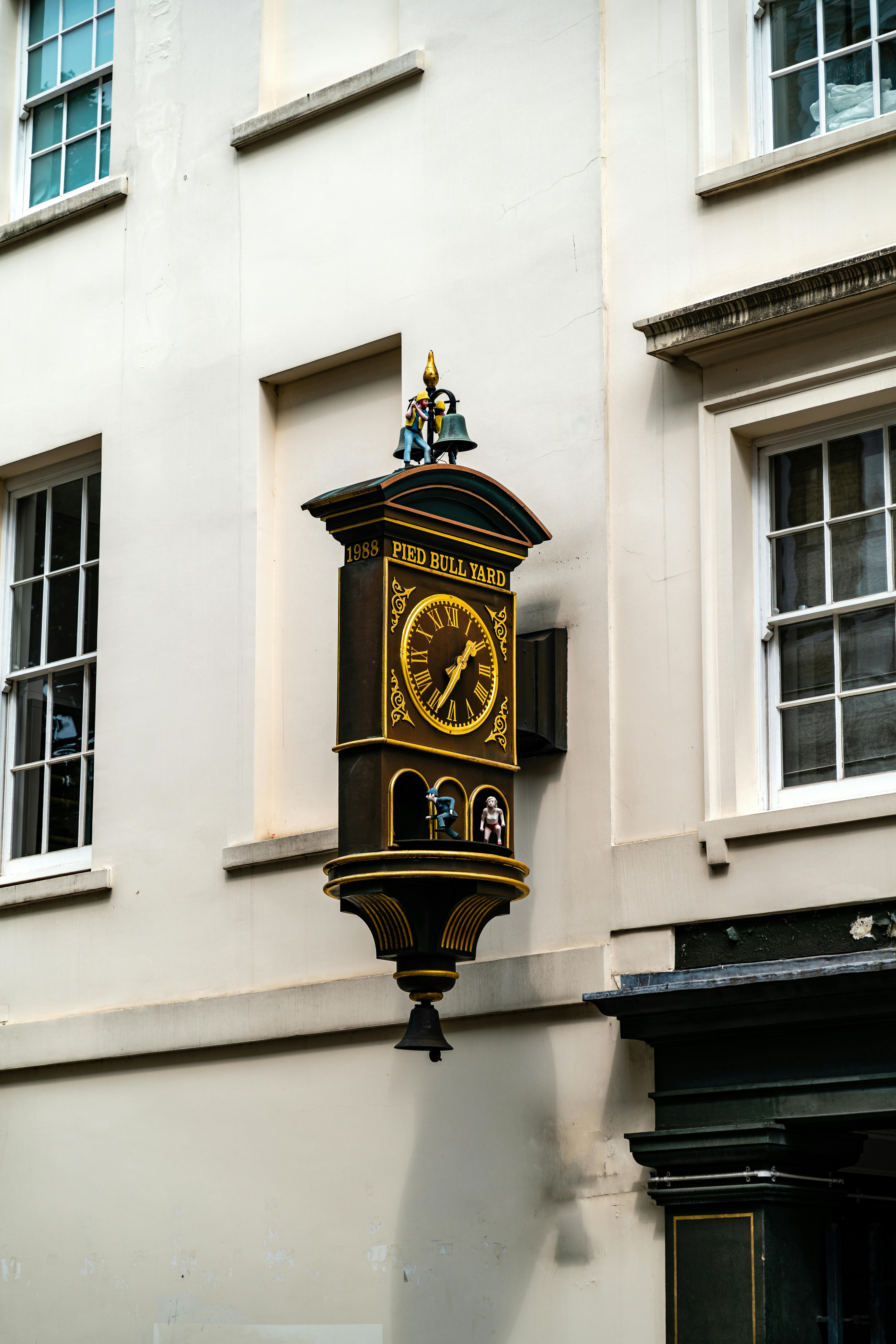 Historic clock at Pied Bull Yard, London. Captures vintage charm and rich history.