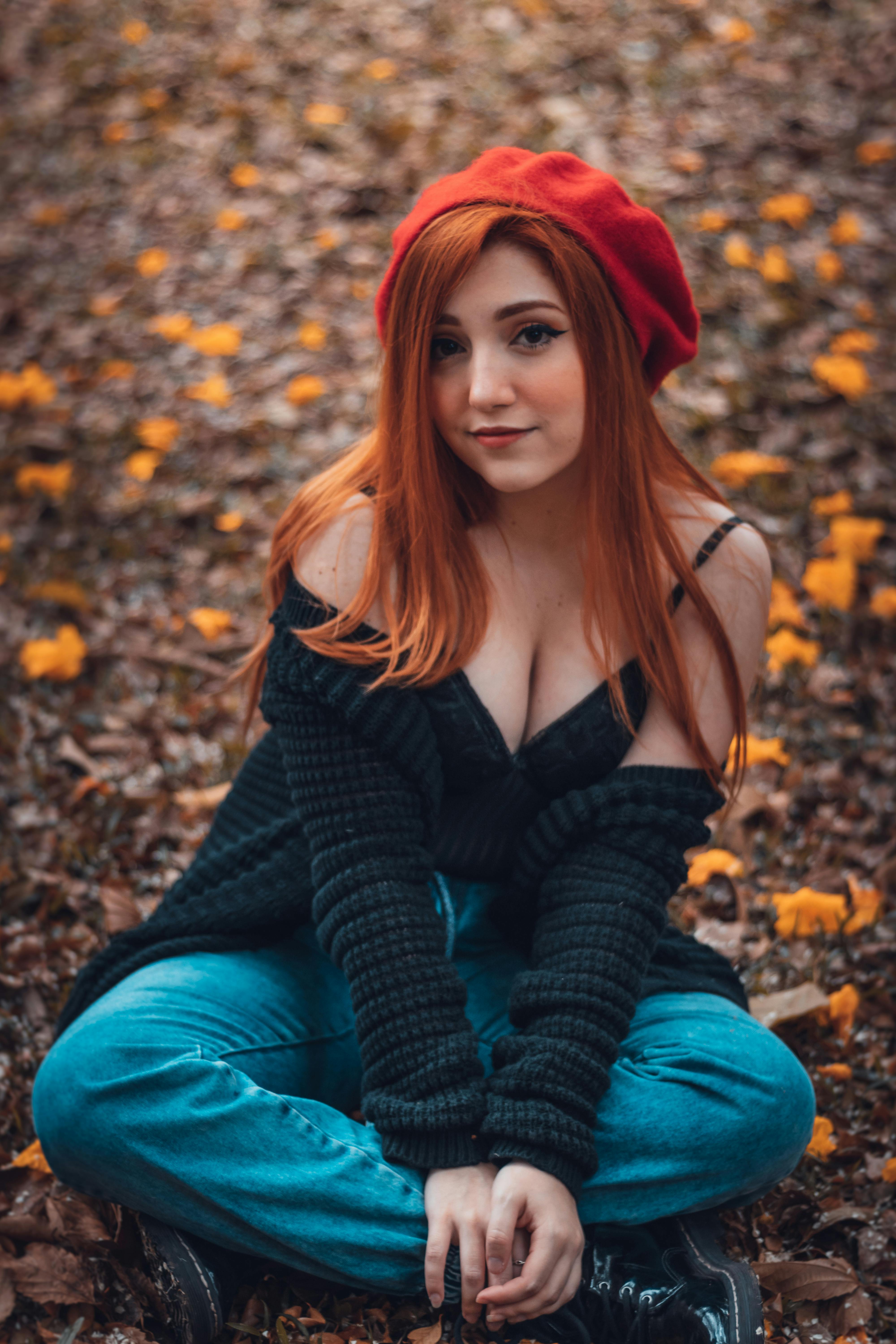 Woman Wearing  Red Cap Sitting on Ground