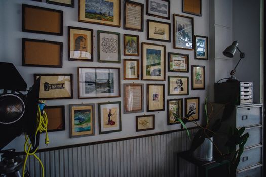 A cozy room with a collection of framed artwork and a modern industrial style.