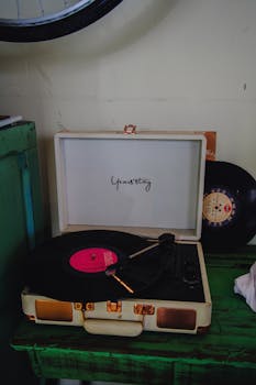 Retro-style record player with pink vinyl and spare records, adding a nostalgic vibe.
