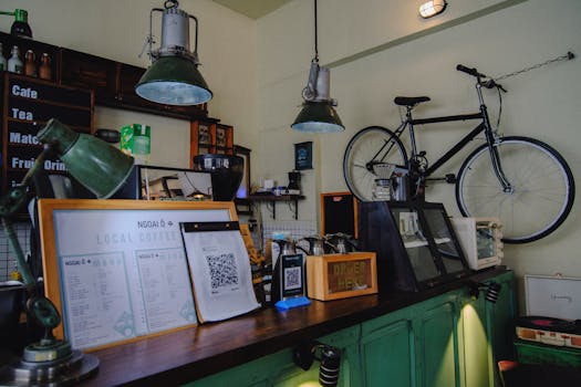 Inviting local coffee shop featuring vintage decor, green accents, and a suspended bicycle.
