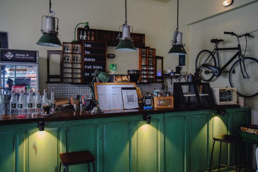 Charming coffee shop interior with vintage decor and a quaint counter display.