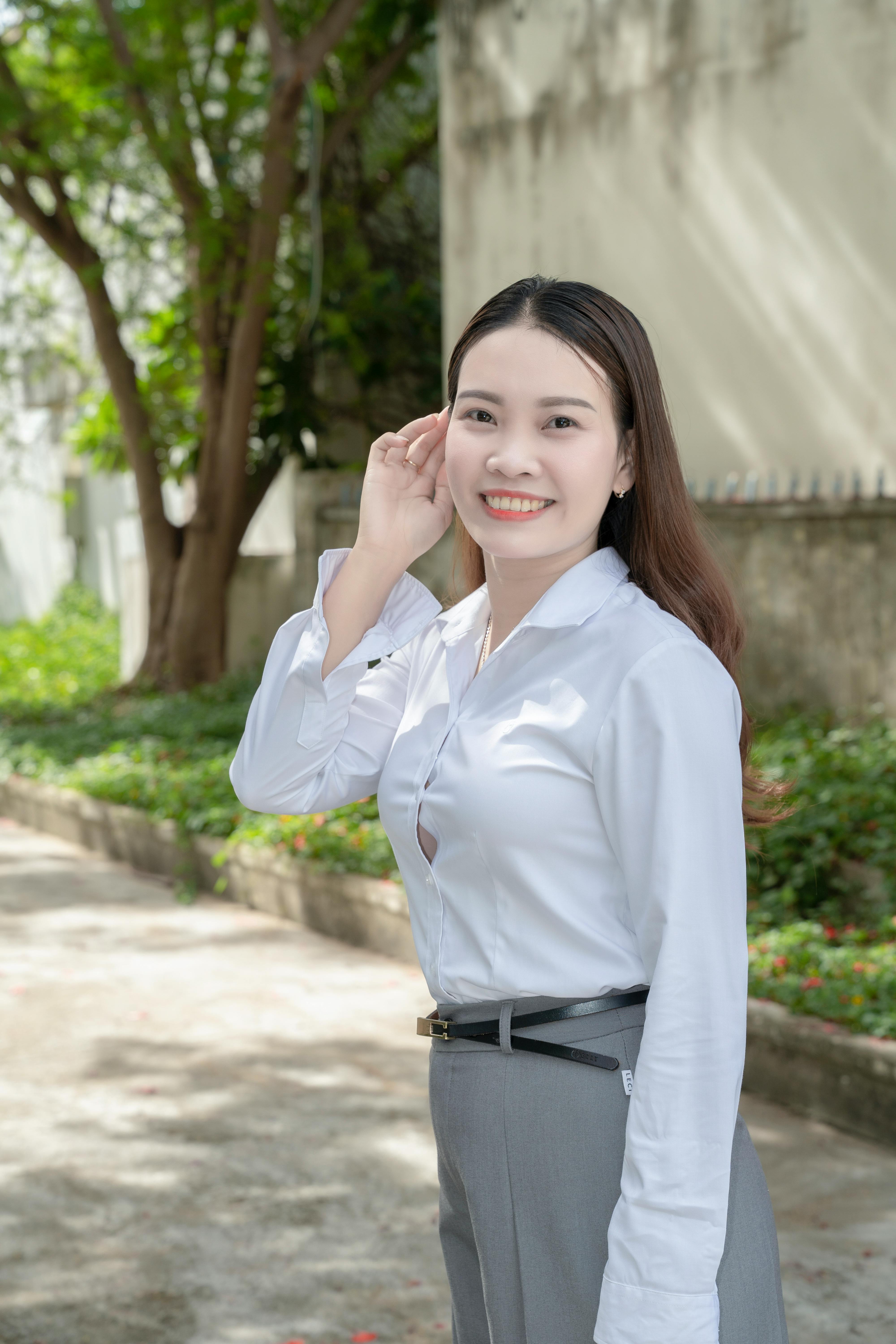 Portrait of a confident young woman outdoors, enjoying sunny weather.