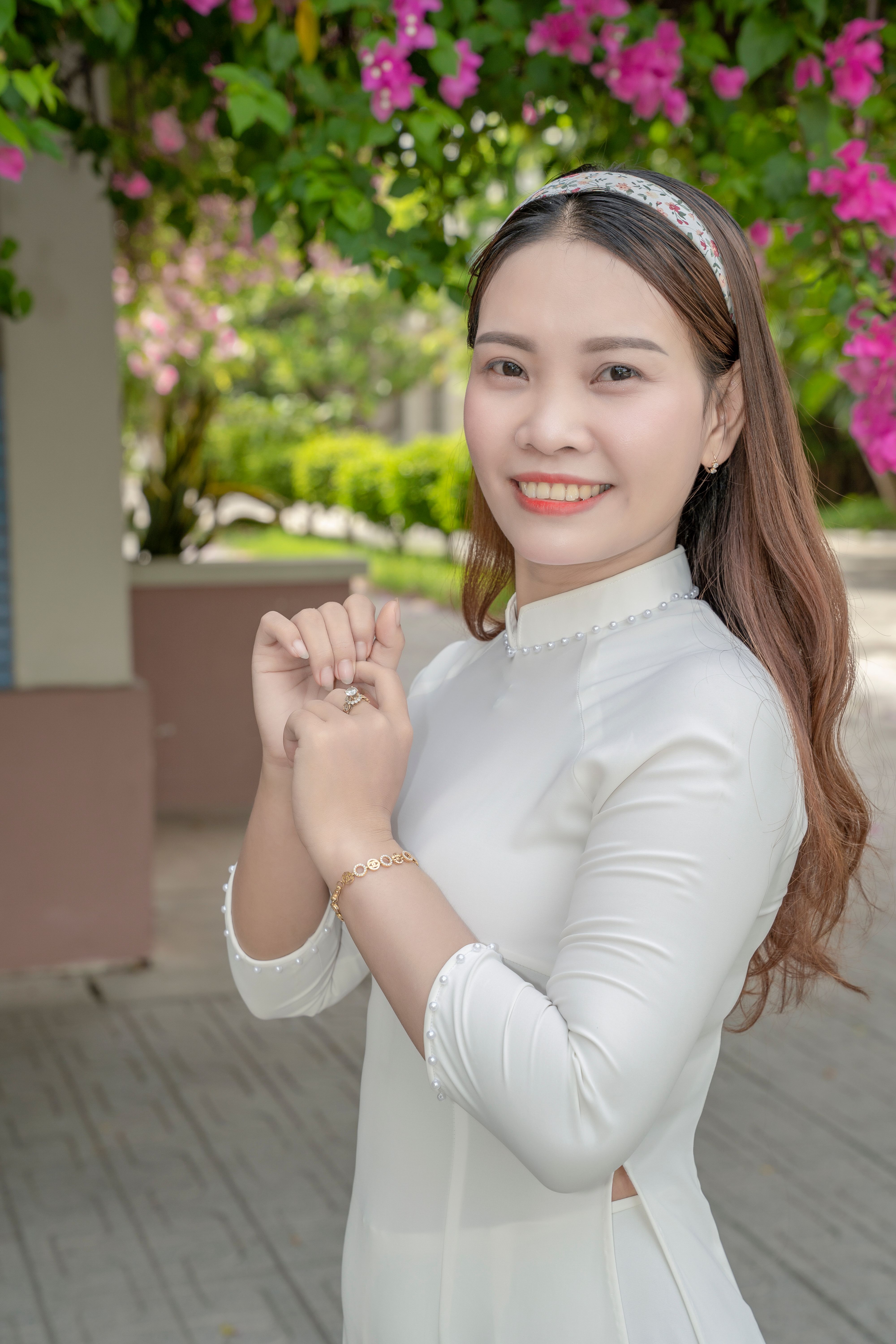 Smiling Woman in White Traditional Dress Outdoors · Free Stock Photo