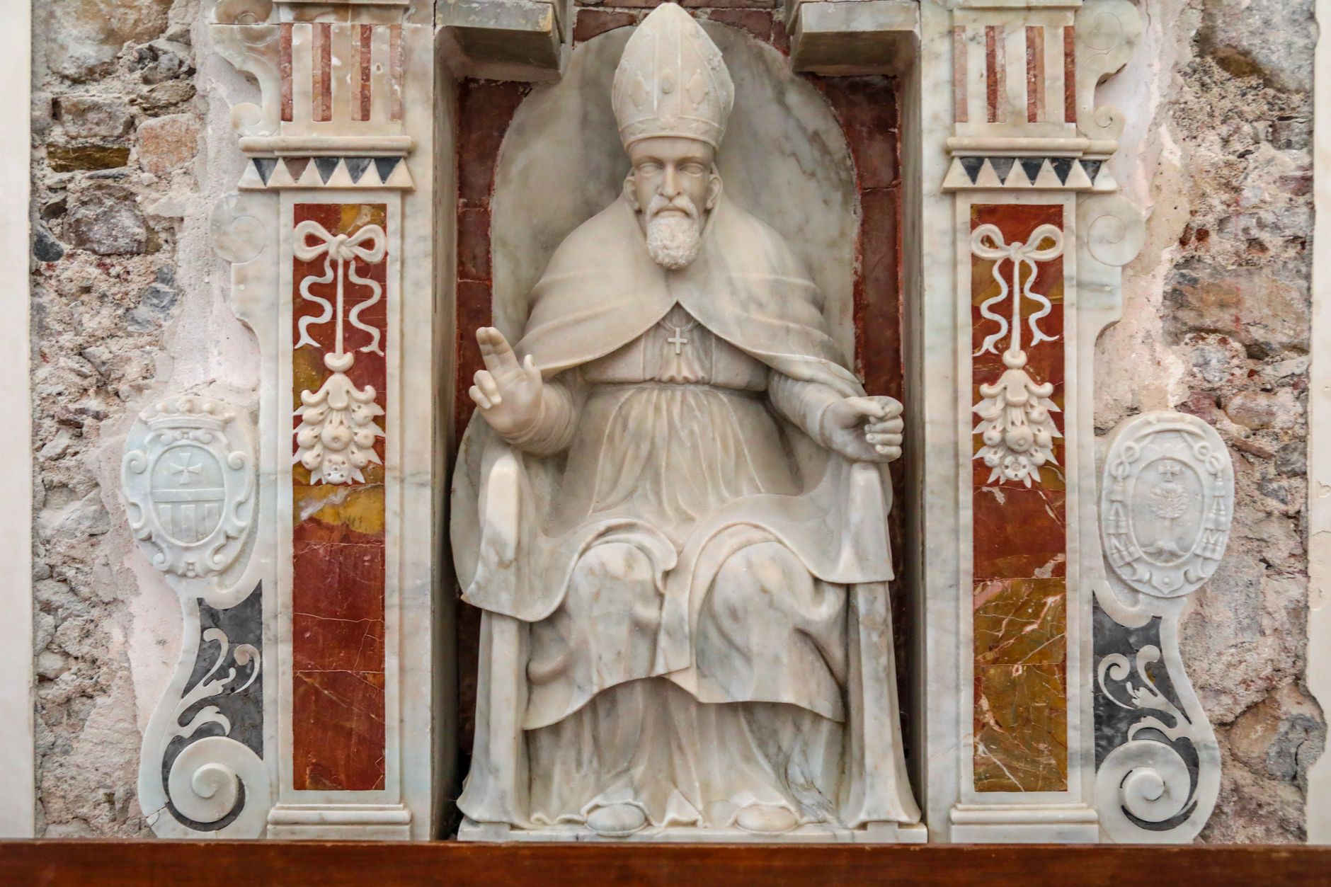 Beautiful marble sculpture of a pope in a historic Sicilian church, highlighting Italy's rich cultural heritage.