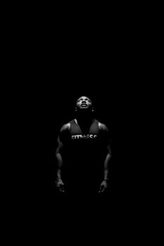 Powerful black and white portrait of a man gazing upwards, capturing strength and focus.