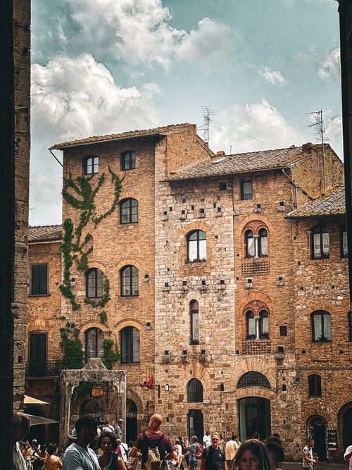 Free Charming old brick building with vibrant street scene in Italy. Stock Photo