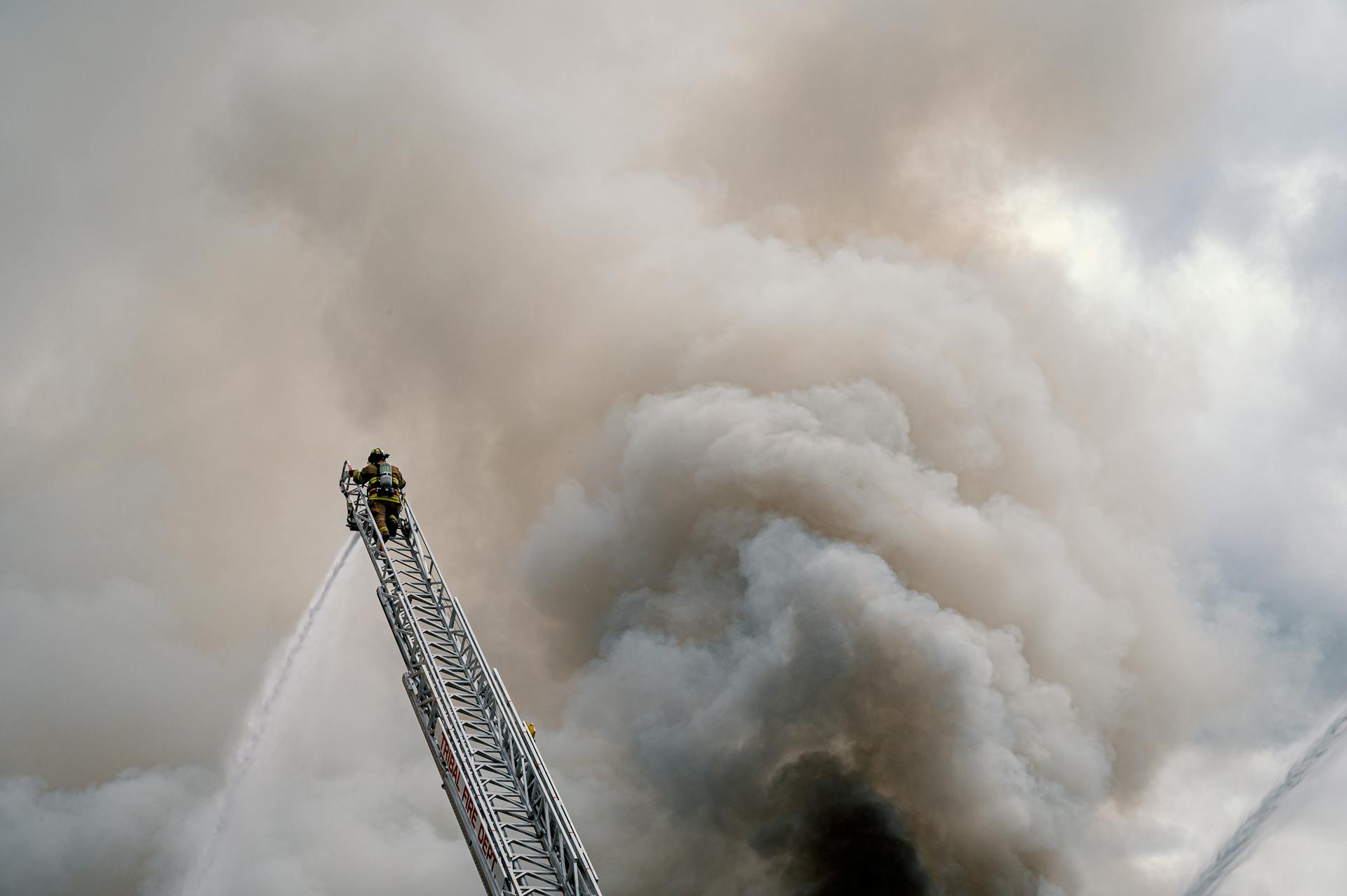 Fire Fighter At The Top Of A Ladder