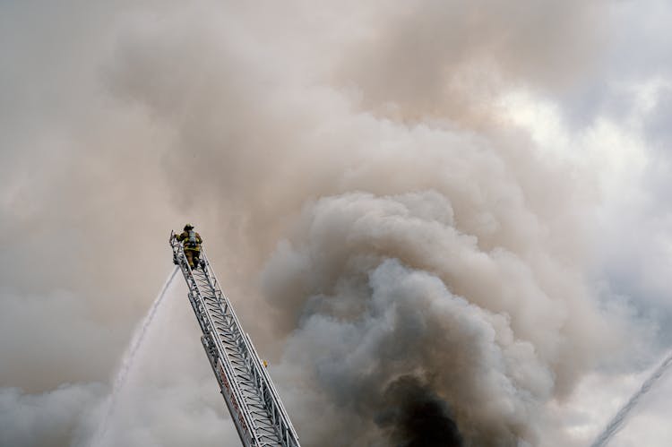 Fire Fighter At The Top Of A Ladder