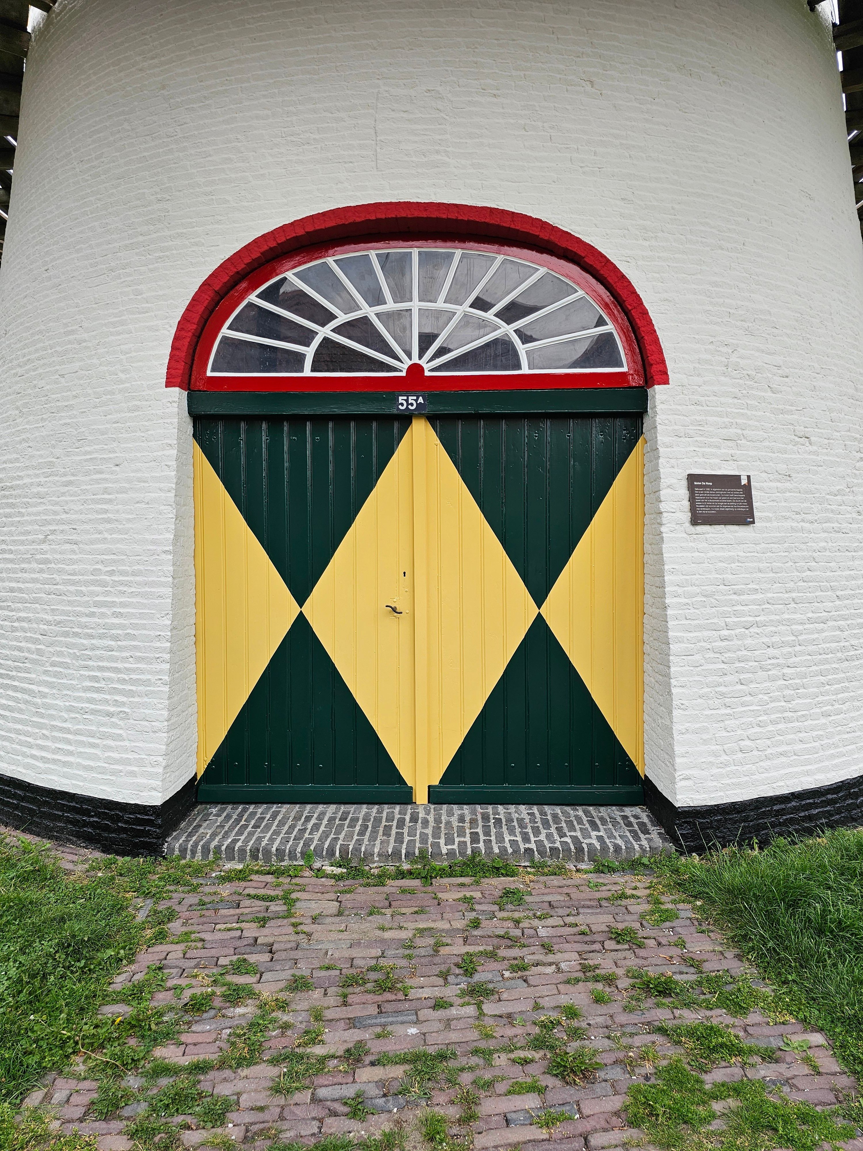 Colorful geometric door on historic building · Free Stock Photo