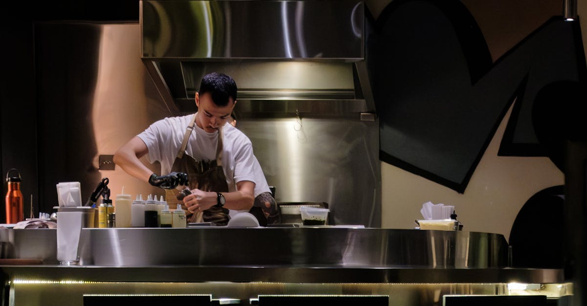 Kitchen Scene With A Man Cooking, Showcasing Culinary Skills And Creativity