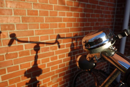 Bicycle handlebar casting shadow on a brick wall in Haarlem, Netherlands.