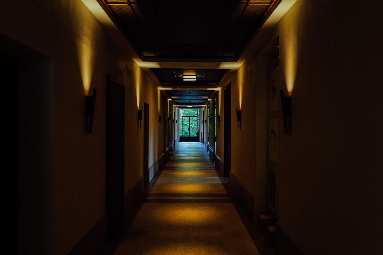 A dimly lit corridor with a moody, mysterious atmosphere