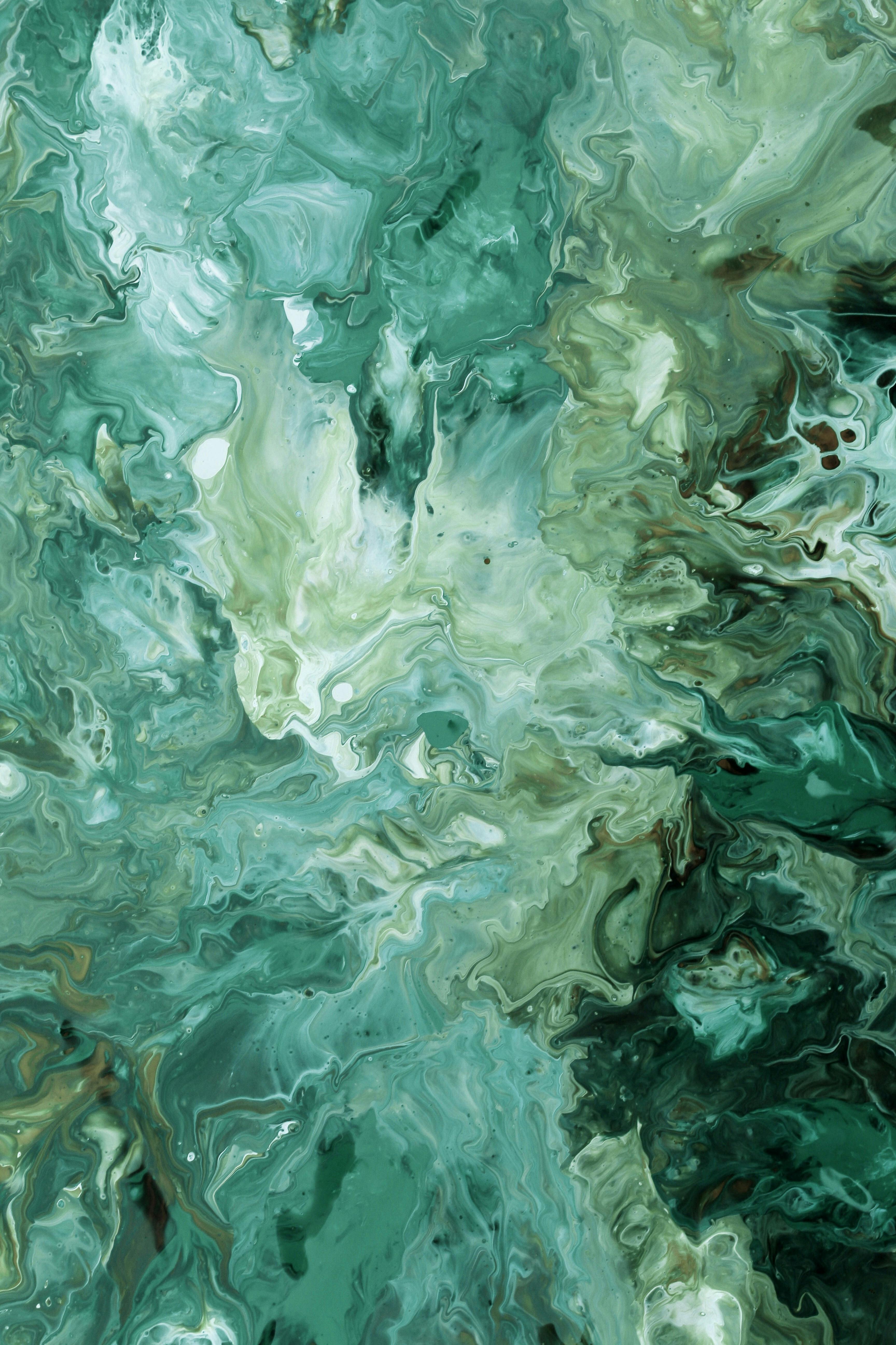 Captivating abstract fluid art with green and white swirls, perfect for creative design projects.