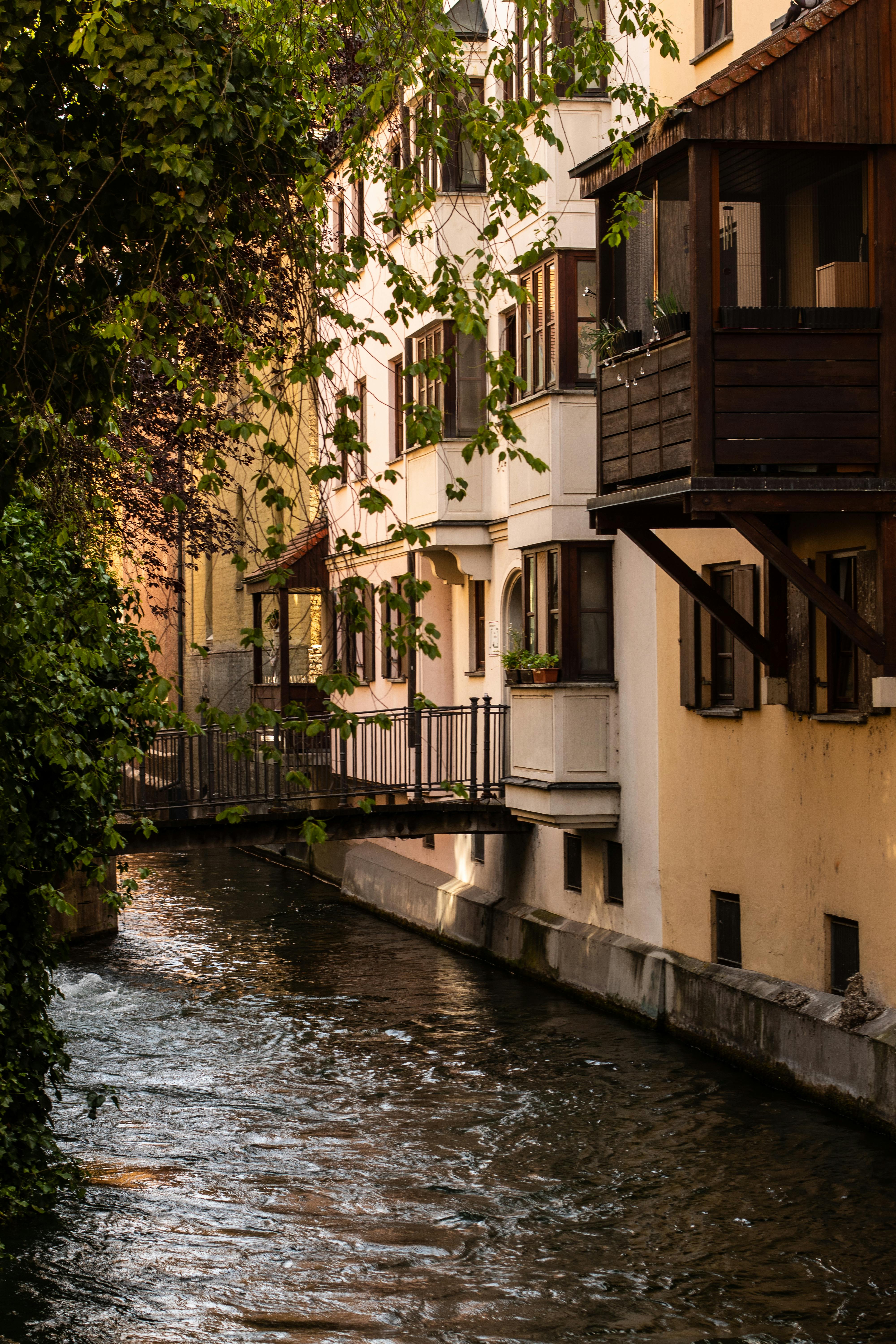 A picturesque view of a canal lined with historic houses in Augsburg, Germany.