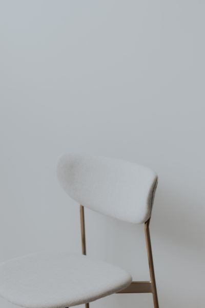Soft white upholstered chair — photo by Andrea Garibay on Pexels