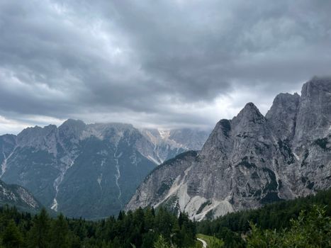 Dramatic view of the Julian Alps under a cloudy sky, perfect for adventure travel.