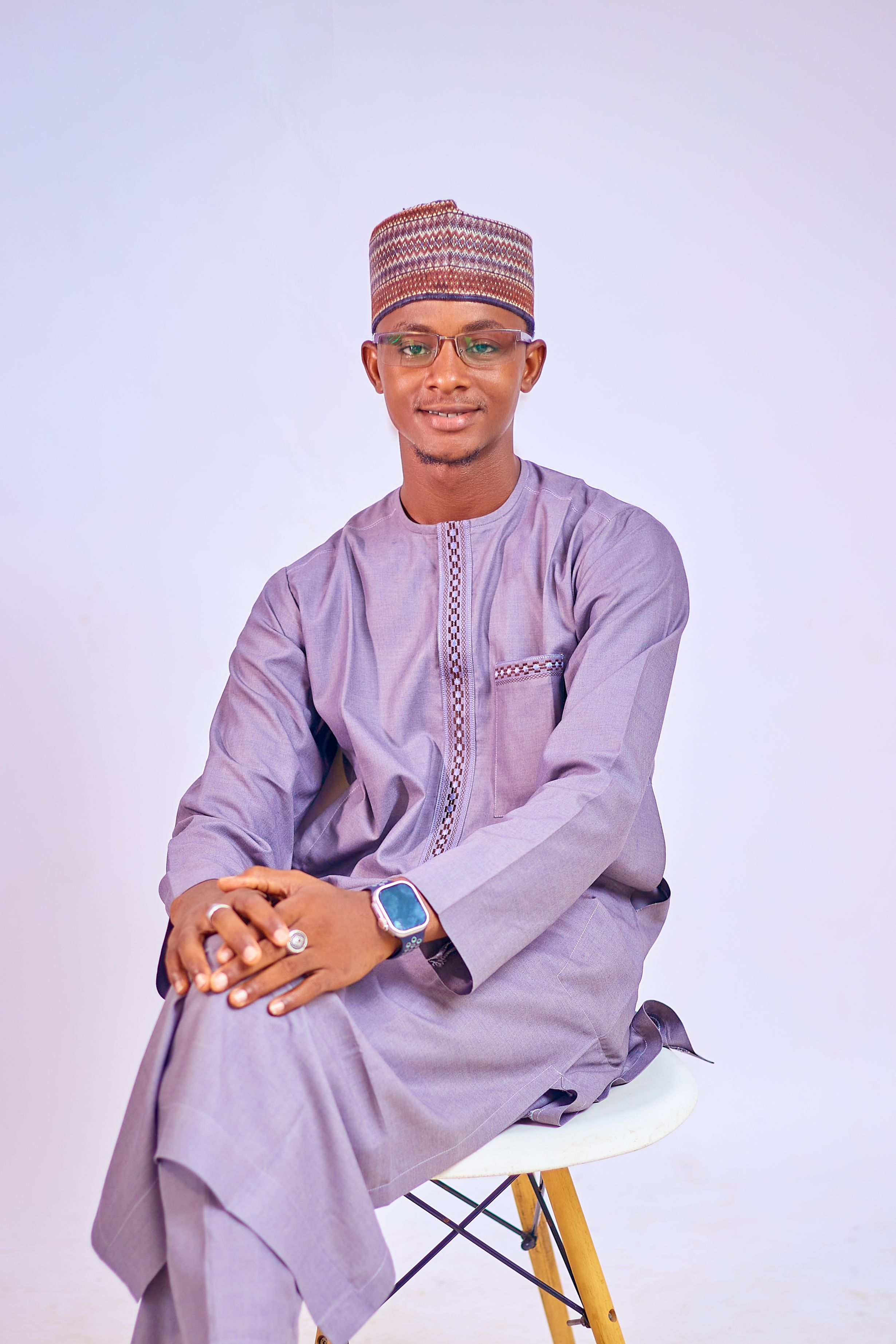 Elegant portrait of a man wearing traditional African clothing and accessories.