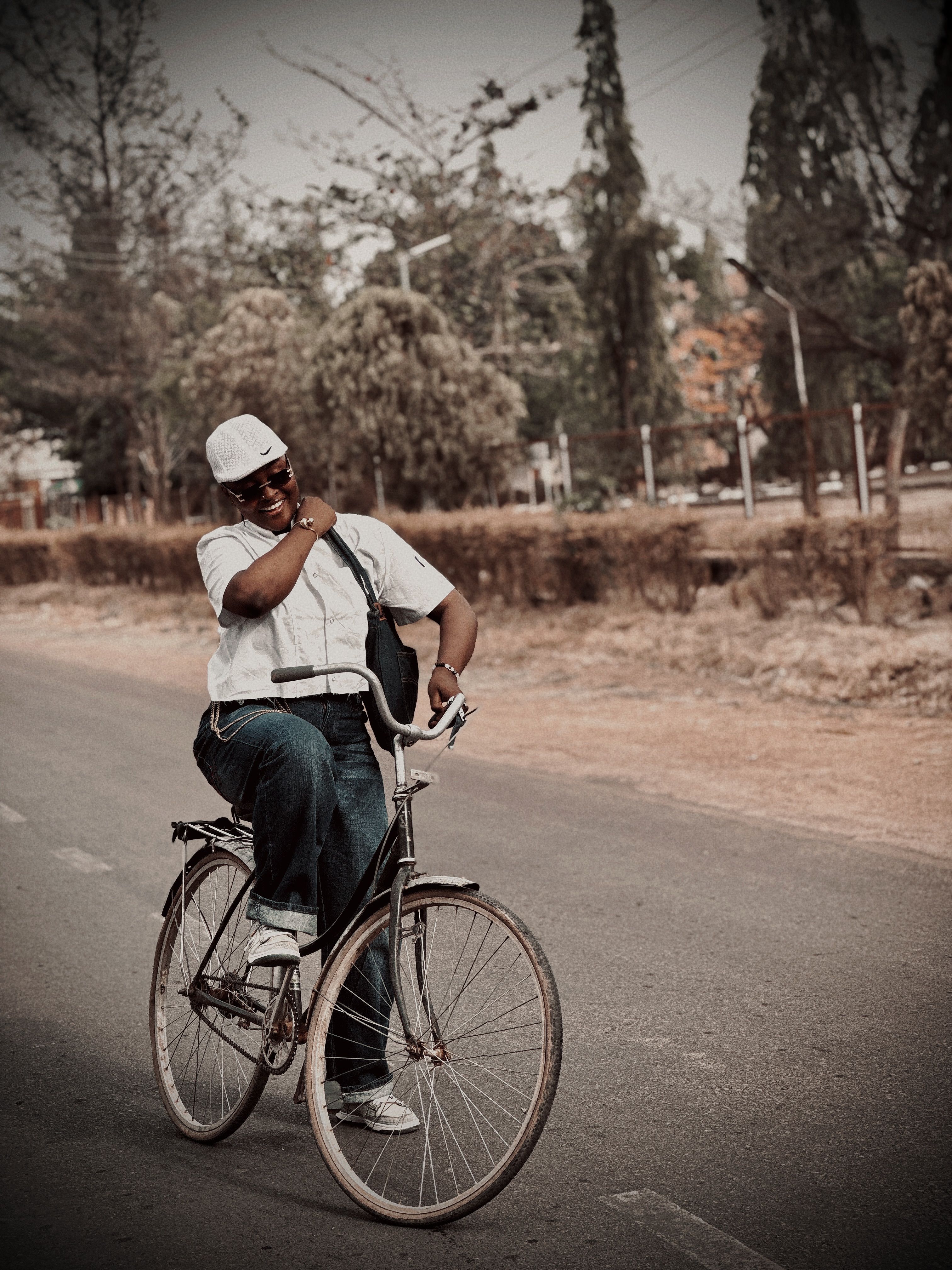 Happy man cycling outdoors in Nigeria showcasing a carefree lifestyle.