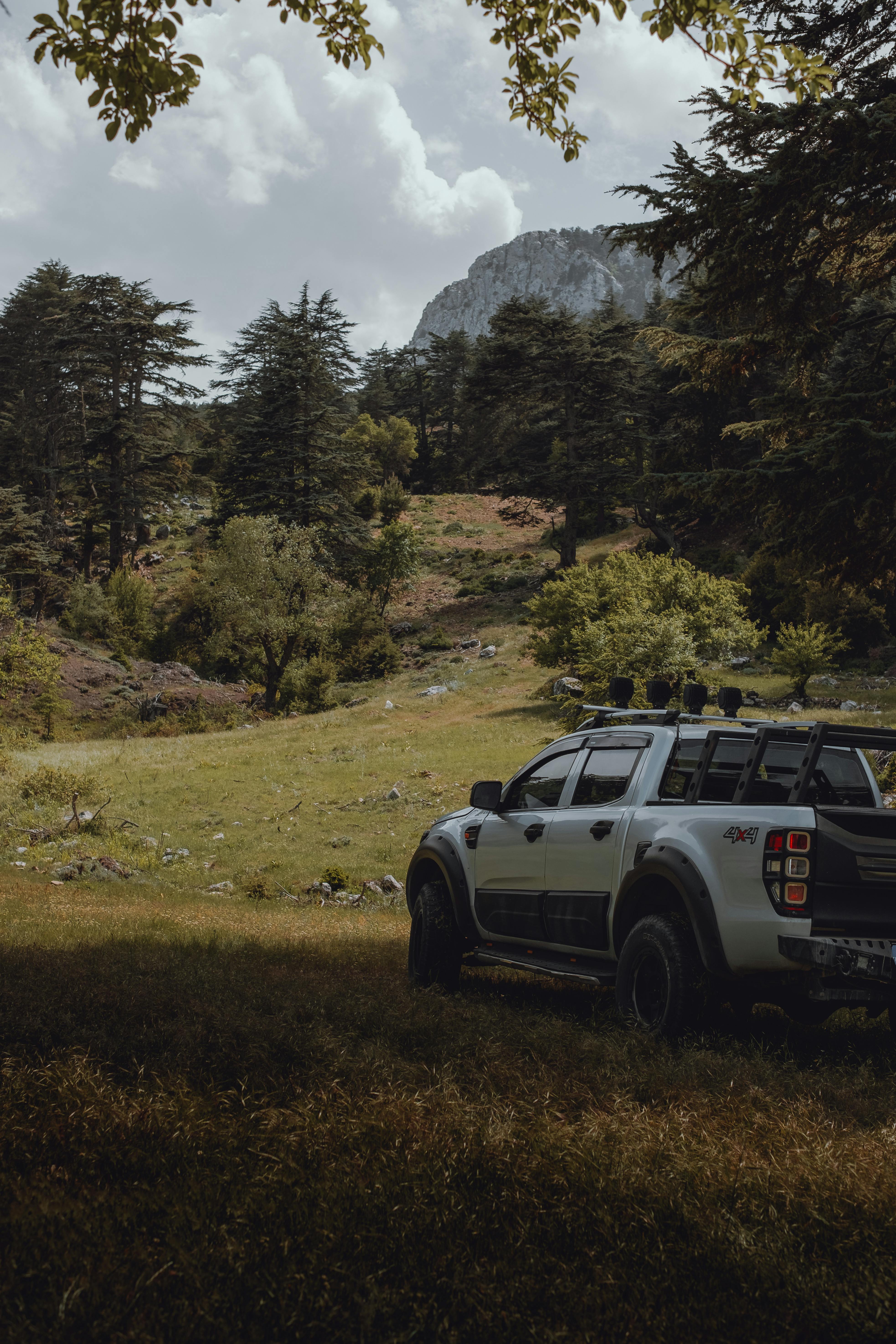 A rugged SUV parked in a lush mountainous area, perfect for adventure seekers.