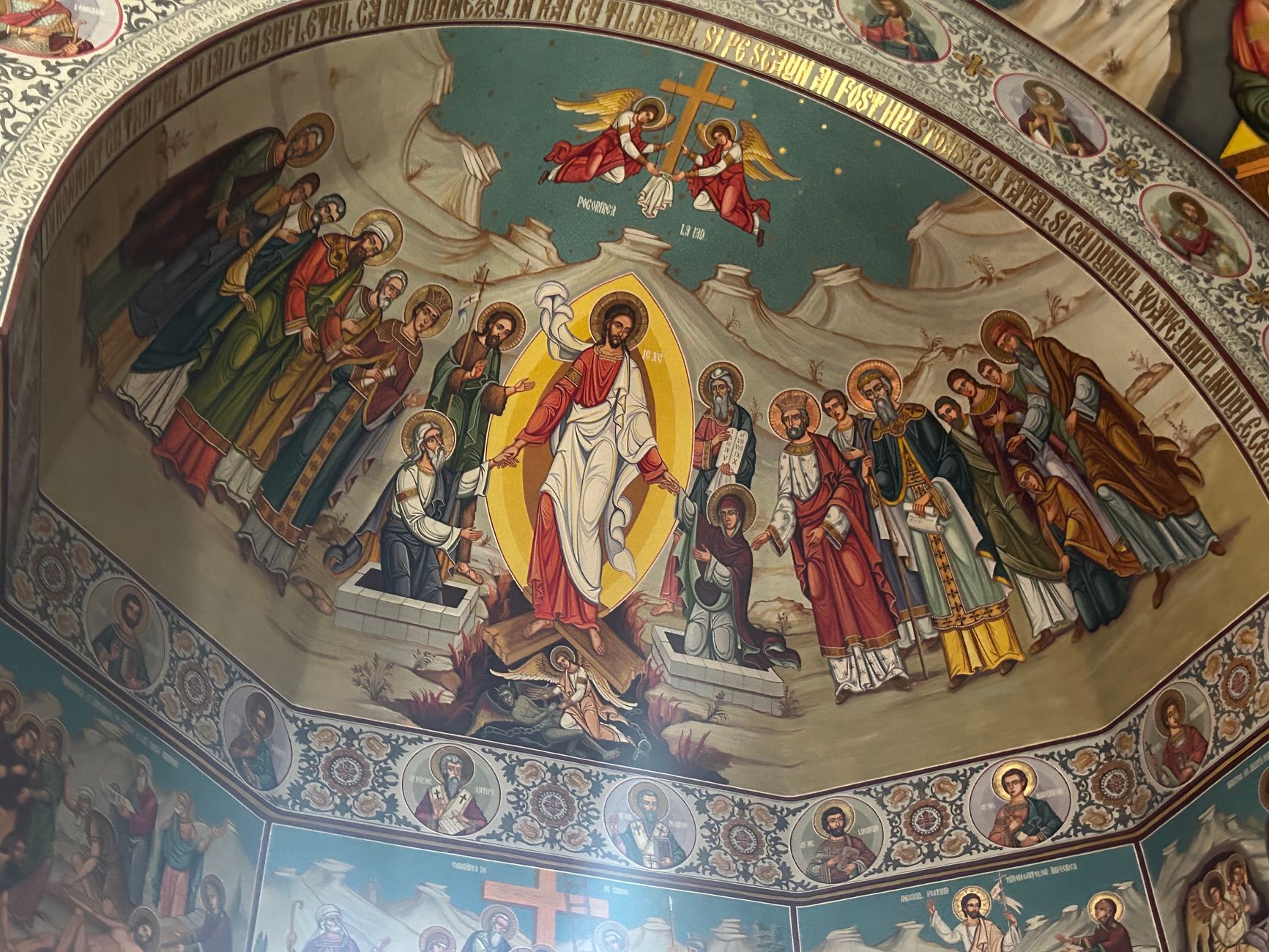 Detailed orthodox church ceiling mural depicting religious figures and scenes, rich in history and color.