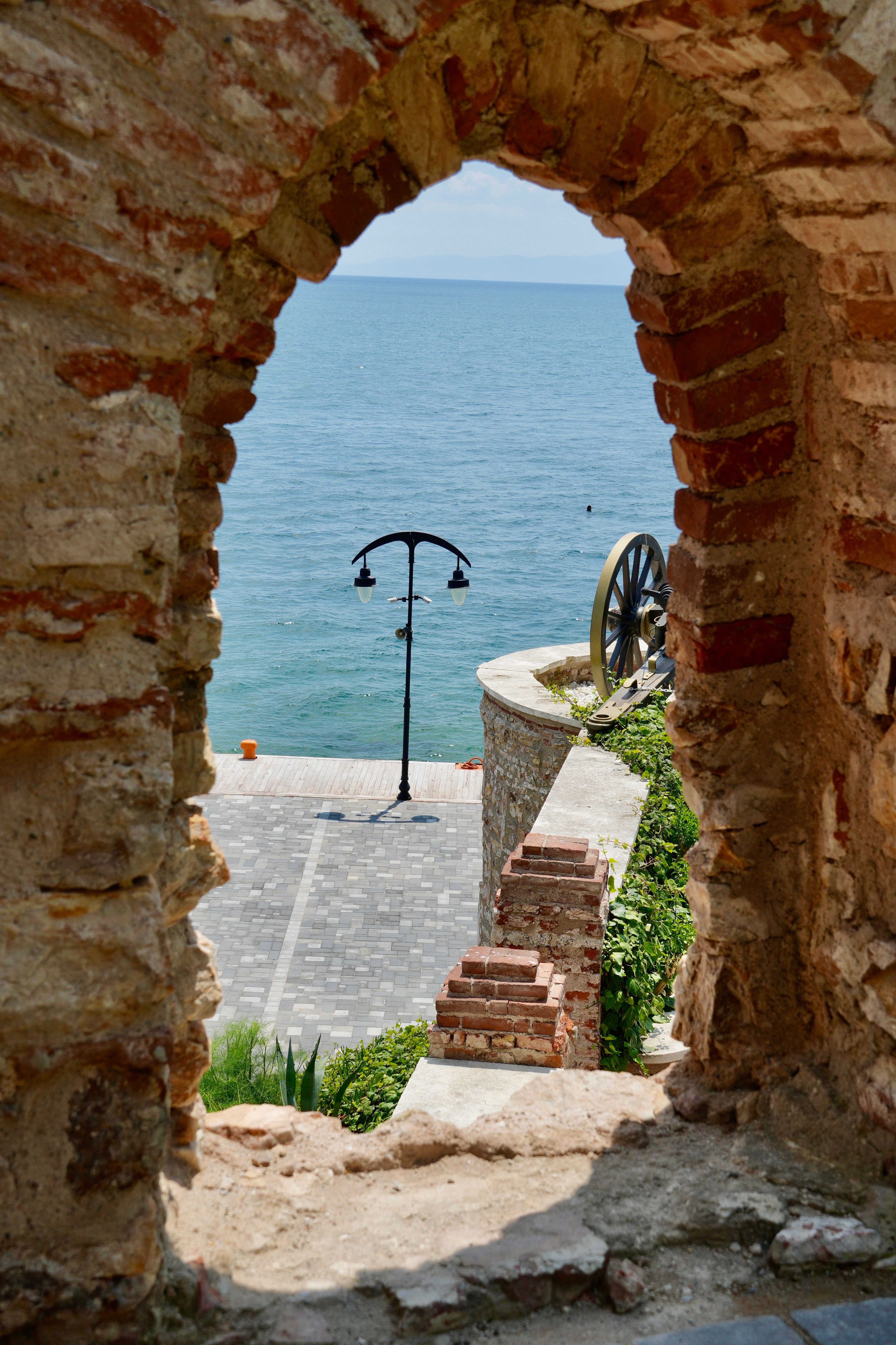 Scenic Coastal View Through Ancient Archway · Free Stock Photo