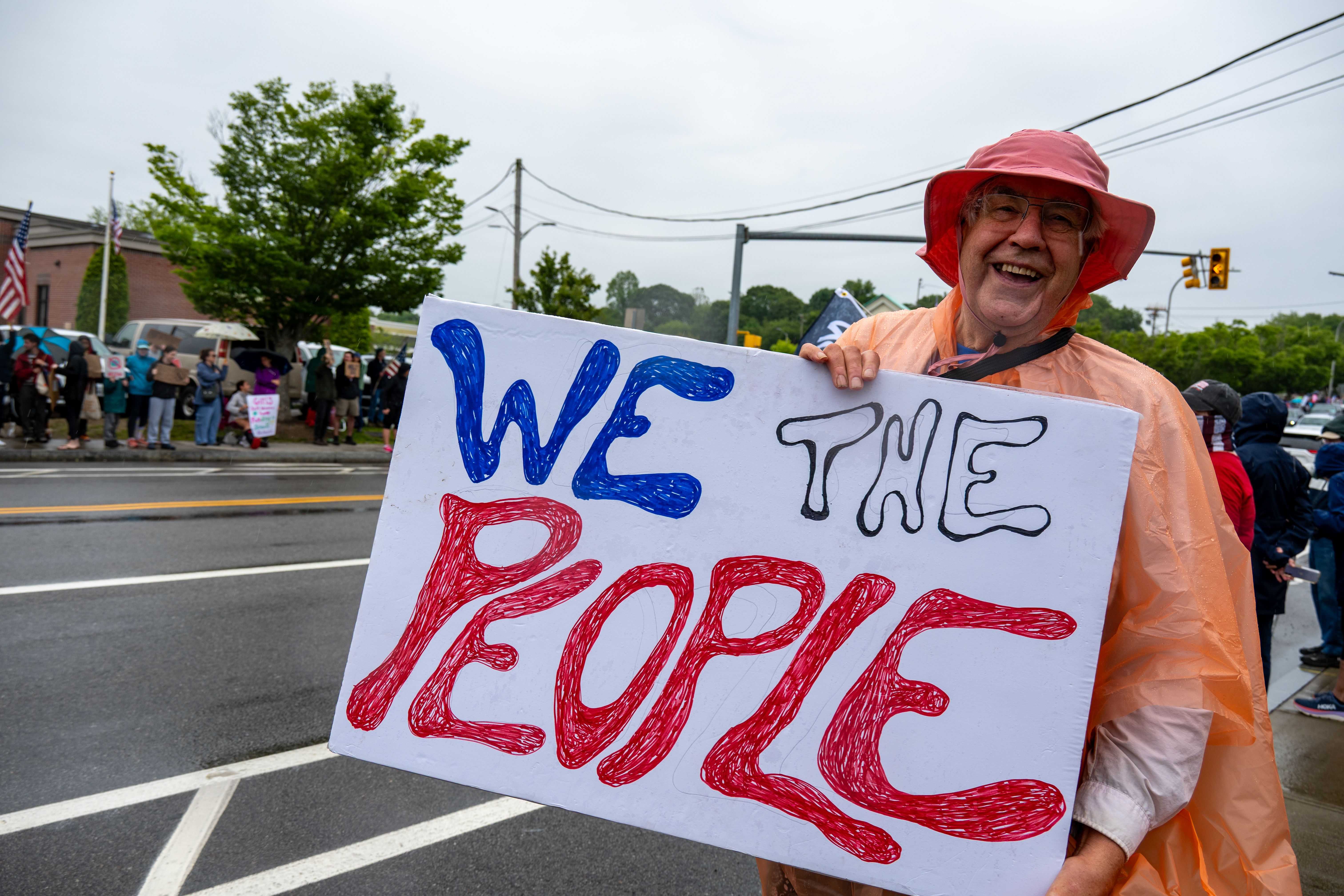 Protestor Holding 'We The People' Sign in Rally · Free Stock Photo