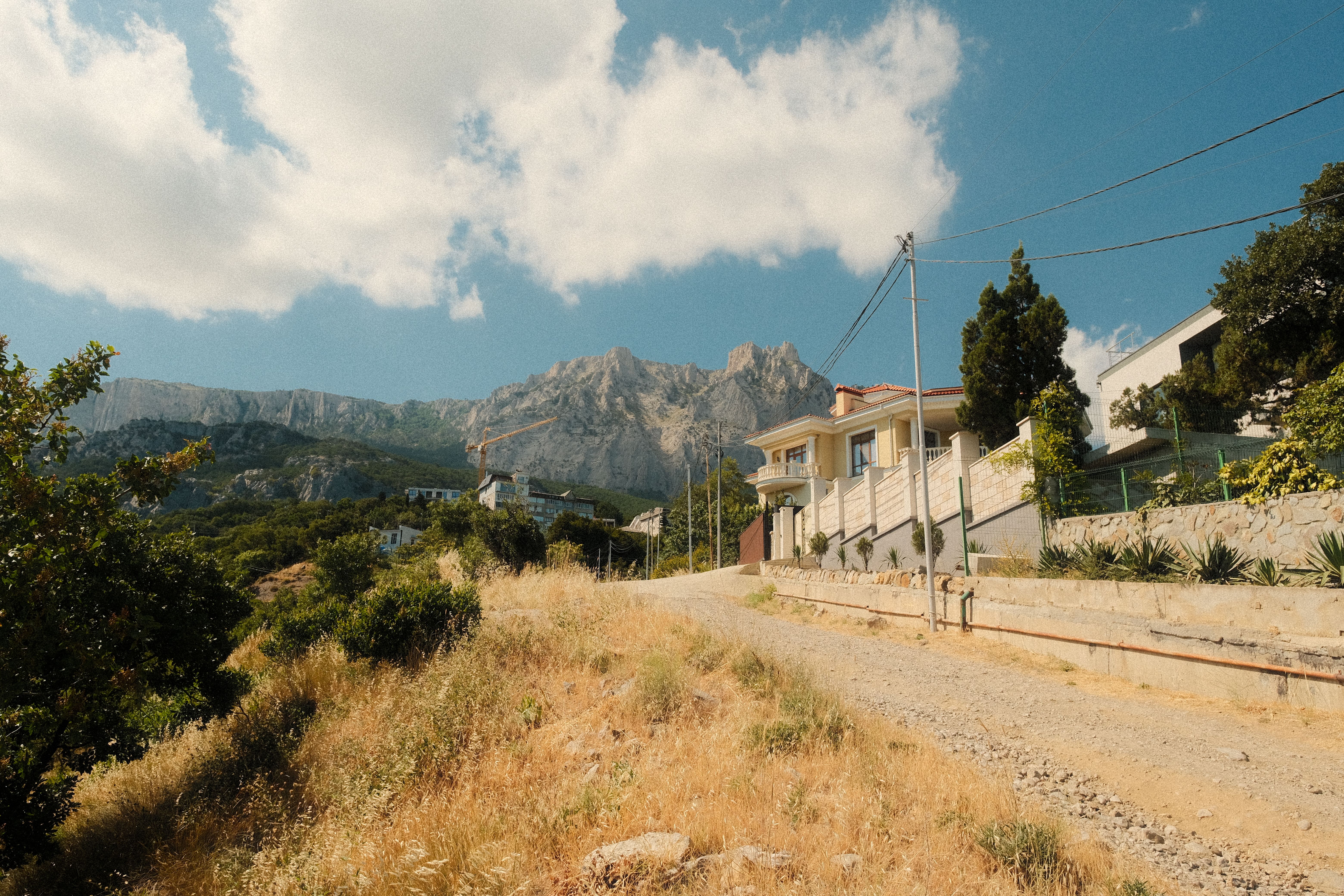 Rural Mountainside Road Leading to Modern Villa · Free Stock Photo