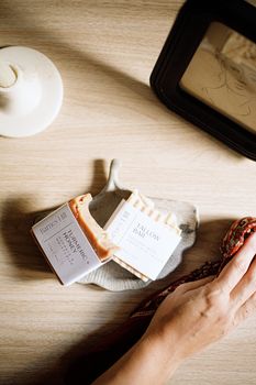 Handmade soaps on a wooden surface with a rustic aesthetic, perfect for natural skincare enthusiasts.