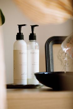 Minimalist flatlay of Barnes Hill artisan skincare in a serene indoor setting.