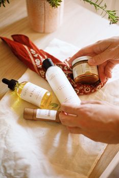 Discover natural, artisan skincare essentials artfully arranged on a wooden surface in warm light.