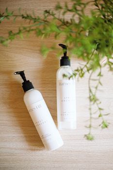 Artisan skincare lotions with minimal packaging highlighted in a natural setting.